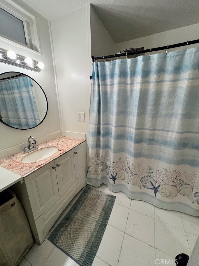 16600 Orange Avenue, Unit 124 Paramount, CA 90723 - Photo 10 of 16 a bathroom with a granite countertop sink and a mirror