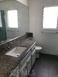 4255 West 5th Street, Unit 203 Los Angeles, CA 90020 - Photo 14 of 25 a bathroom with a granite countertop sink and a toilet