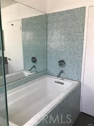 a bathroom with a tub and shower