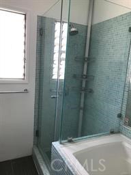 4255 West 5th Street, Unit 203 Los Angeles, CA 90020 - Photo 16 of 25 a bathroom with a tub and shower