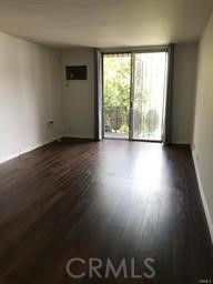 4255 West 5th Street, Unit 203 Los Angeles, CA 90020 - Photo 9 of 25 a view of a livingroom with wooden floor and a floor to ceiling window
