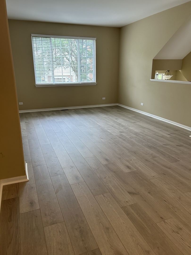 2005 Concord Drive McHenry, IL 60050 - Photo 2 of 12 an empty room with wooden floor and windows