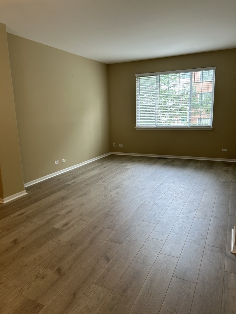 2005 Concord Drive McHenry, IL 60050 - Photo 3 of 12 an empty room with wooden floor and windows