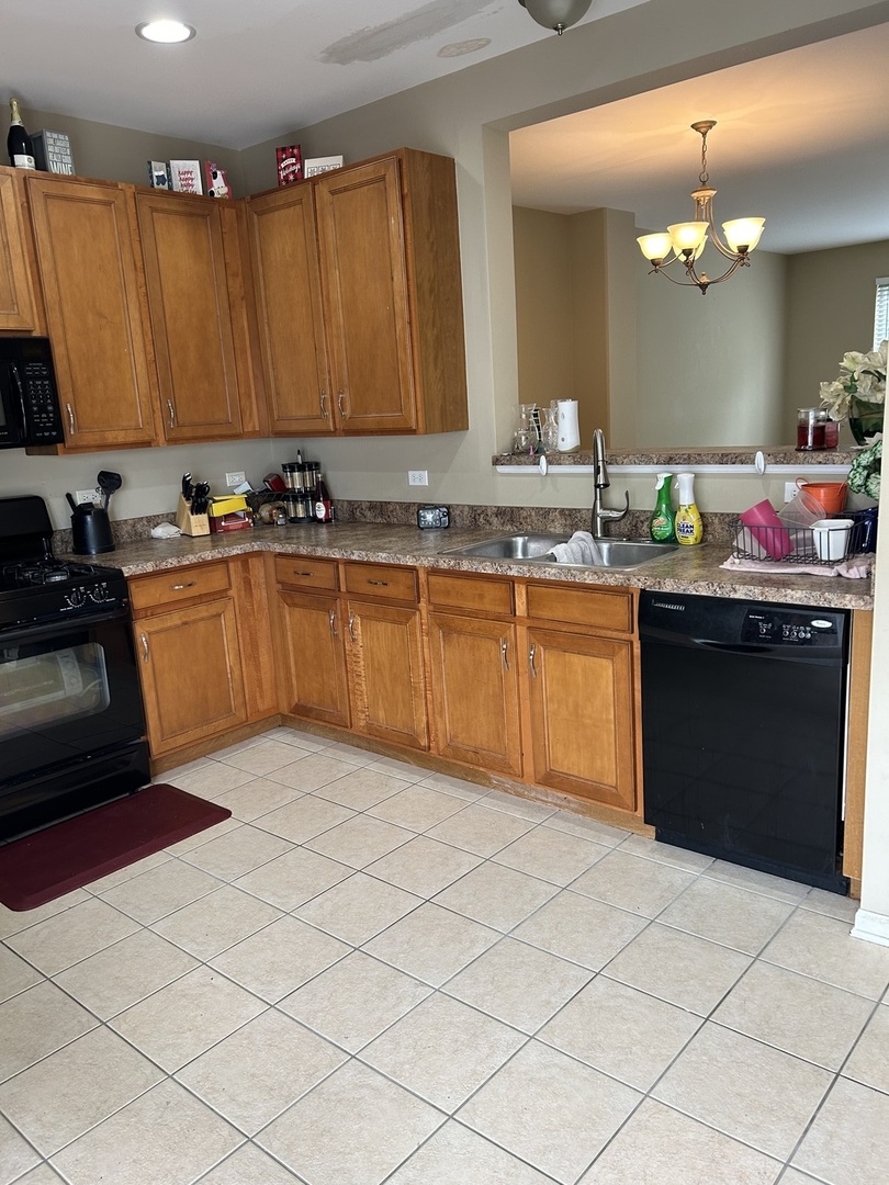 2005 Concord Drive McHenry, IL 60050 - Photo 4 of 12 a kitchen with stainless steel appliances granite countertop a sink counter space cabinets and a large window