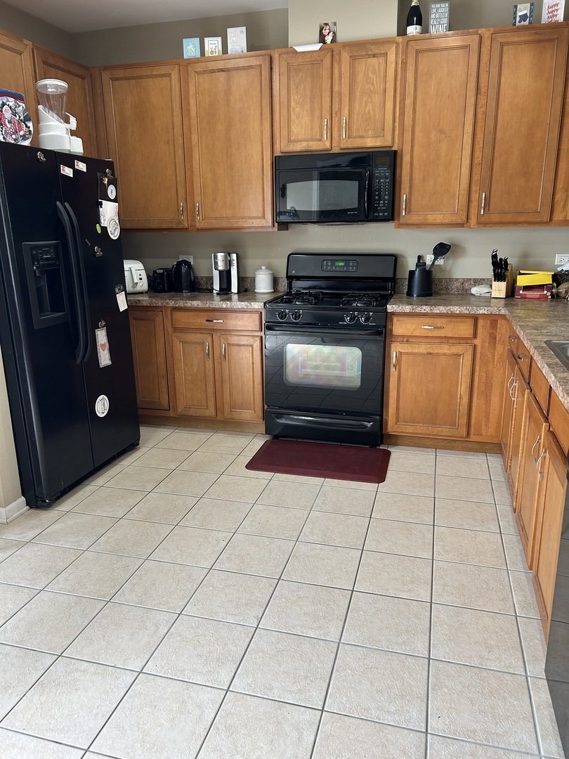 2005 Concord Drive McHenry, IL 60050 - Photo 5 of 12 a kitchen with a sink a stove and cabinets