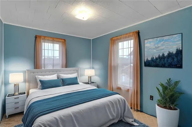 a bedroom with a large bed and a potted plant