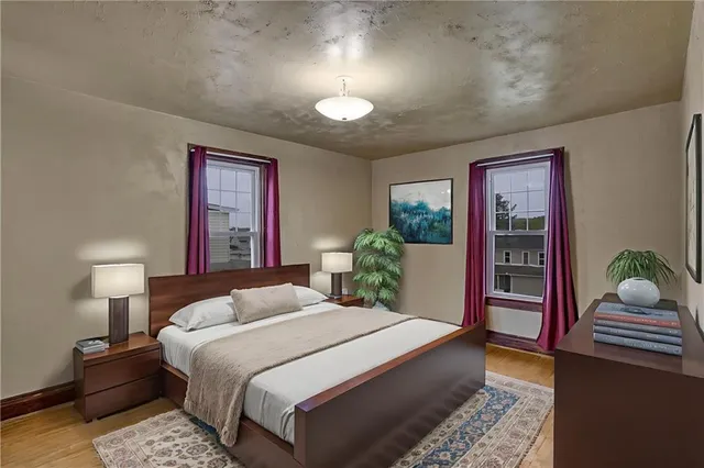 a bedroom with a large bed and a chandelier