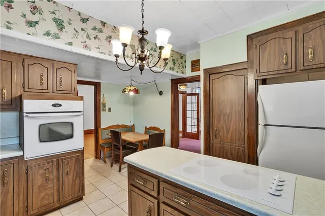a kitchen with stainless steel appliances a refrigerator sink and cabinets
