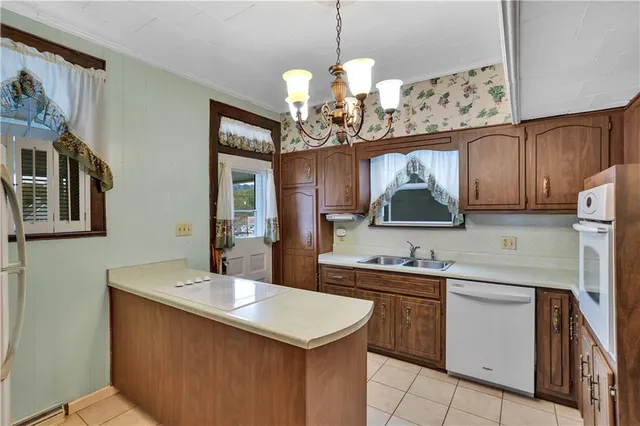 a kitchen with a sink a stove and cabinets