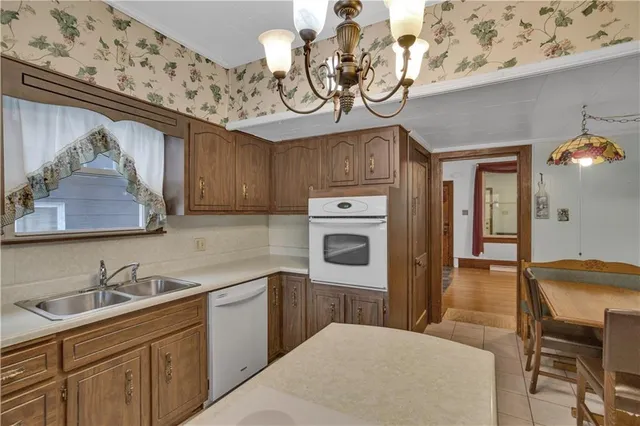 a kitchen with cabinets a sink and appliances