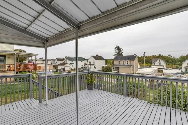 a view of a balcony with wooden floor