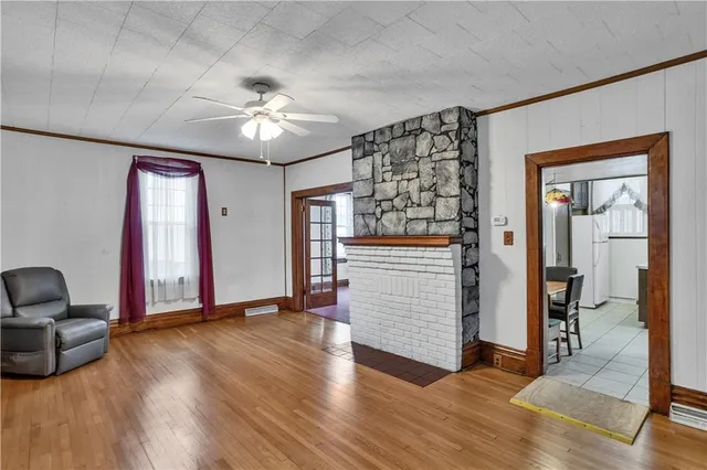 a view of a livingroom with wooden floor and workspace