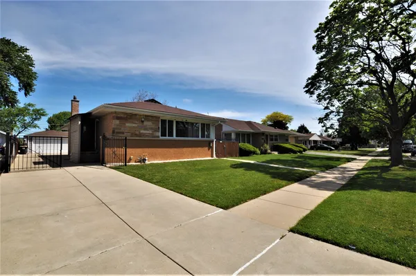 a view of house with yard and entertaining space