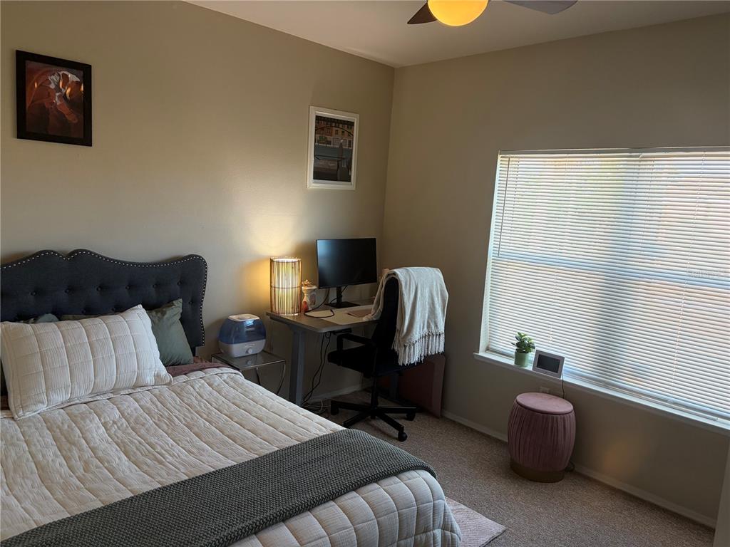 10764 70th Avenue, Unit 2301 Seminole, FL 33772 - Photo 12 of 19 a bedroom with a bed and a chair