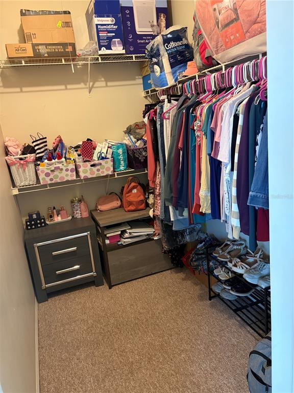 10764 70th Avenue, Unit 2301 Seminole, FL 33772 - Photo 14 of 19 a view of walk in closet with clothes and shoes