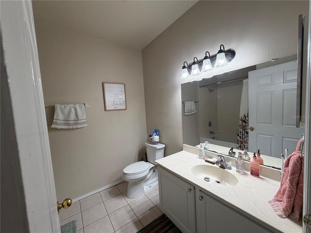 10764 70th Avenue, Unit 2301 Seminole, FL 33772 - Photo 16 of 19 a bathroom with a sink mirror and toilet