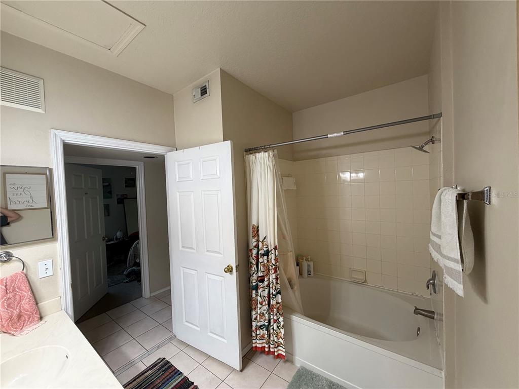 10764 70th Avenue, Unit 2301 Seminole, FL 33772 - Photo 17 of 19 a bathroom with a shower and a tub