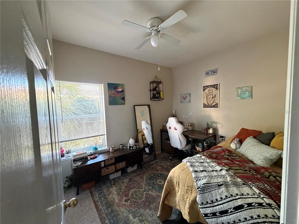 10764 70th Avenue, Unit 2301 Seminole, FL 33772 - Photo 19 of 19 a bed room with a bed and a chandelier