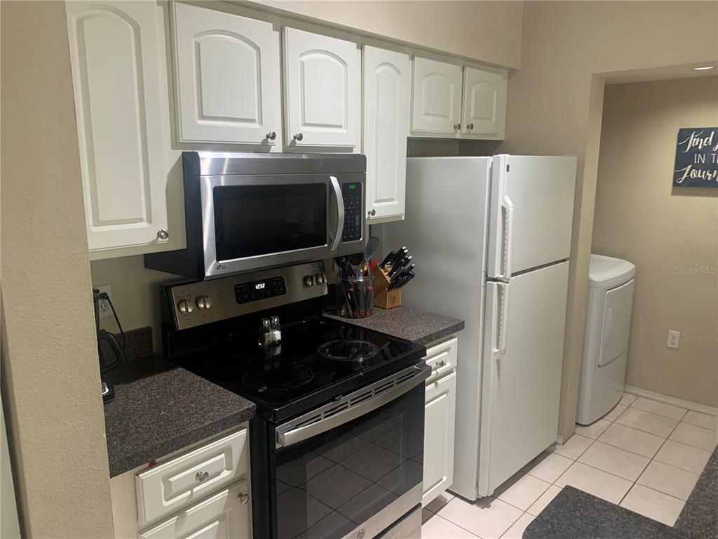 10764 70th Avenue, Unit 2301 Seminole, FL 33772 - Photo 6 of 19 a kitchen with stainless steel appliances granite countertop a refrigerator stove and microwave