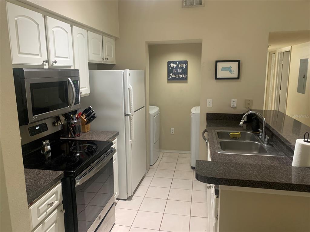 10764 70th Avenue, Unit 2301 Seminole, FL 33772 - Photo 7 of 19 a kitchen with a sink appliances and cabinets