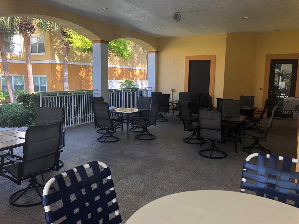 10764 70th Avenue, Unit 2301 Seminole, FL 33772 - Photo 8 of 19 a living room with furniture and floor to ceiling windows
