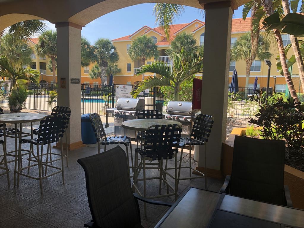 10764 70th Avenue, Unit 2301 Seminole, FL 33772 - Photo 9 of 19 a view of a dining room with furniture and chandelier