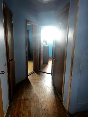 a view of hallway with wooden floor
