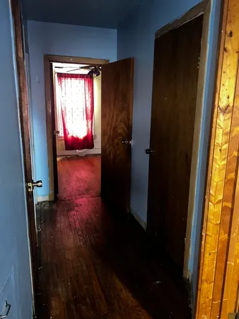 a view of hallway with furniture and a window