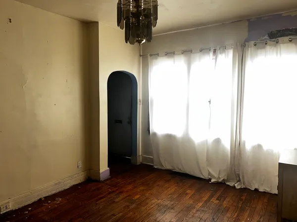 a view of a room with wooden floor
