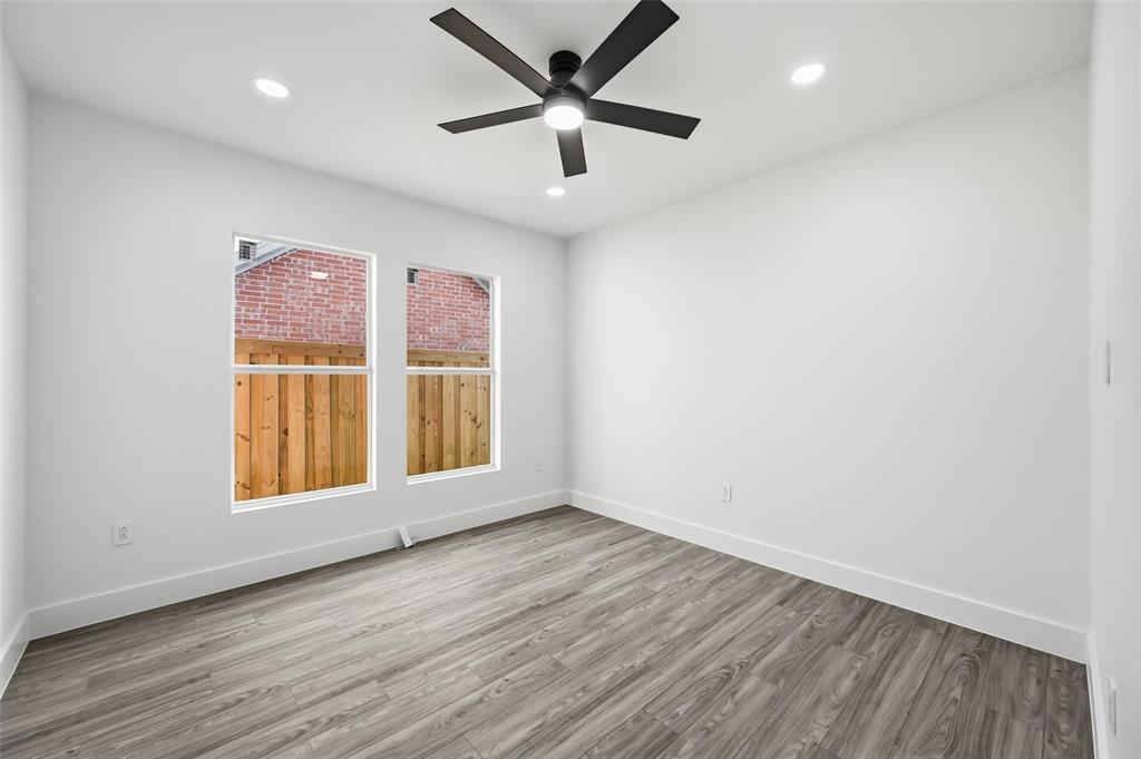 2618 Gooch Street Dallas, TX 75241 - Photo 18 of 28 a view of an empty room with window and wooden floor