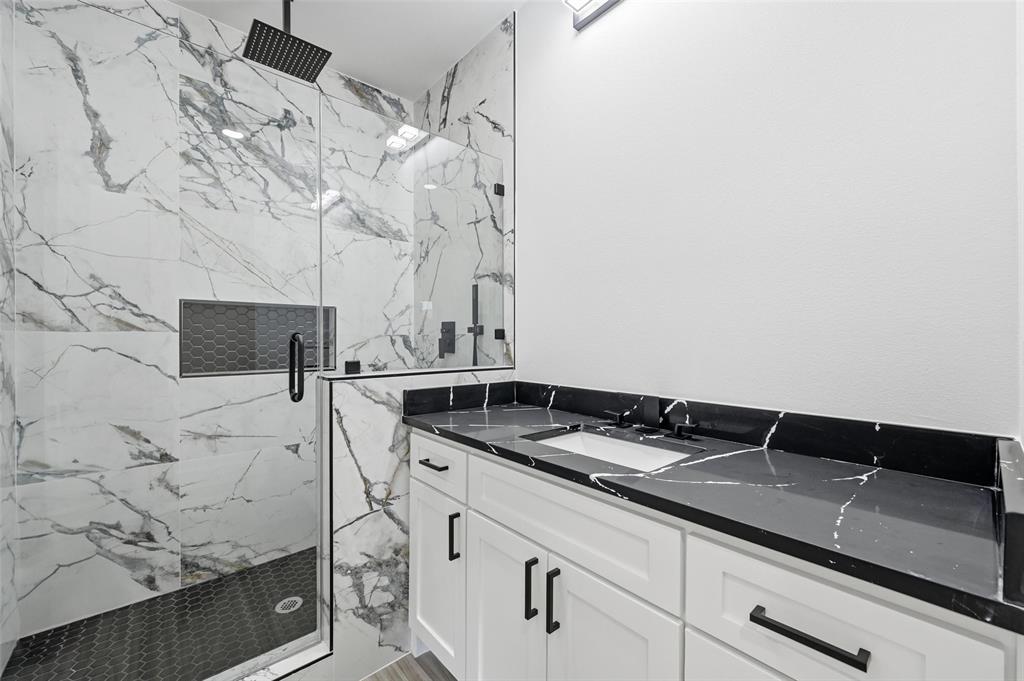 2618 Gooch Street Dallas, TX 75241 - Photo 19 of 28 a bathroom with a granite countertop sink and cabinets