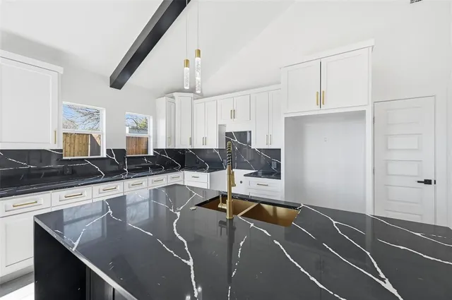 a kitchen with stainless steel appliances granite countertop a stove and a sink