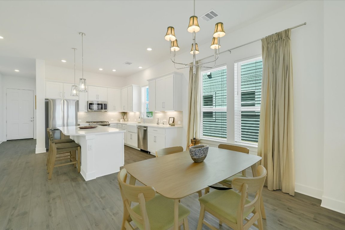 111 Breda Avenue Bastrop, TX 78602 - Photo 1 of 1 a open dining room with kitchen island stainless steel appliances furniture large window and wooden floor