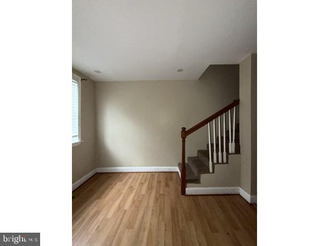 1611 Lemmon Street Baltimore, MD 21223 - Photo 3 of 20 a view of a hallway with wooden floor and stairs