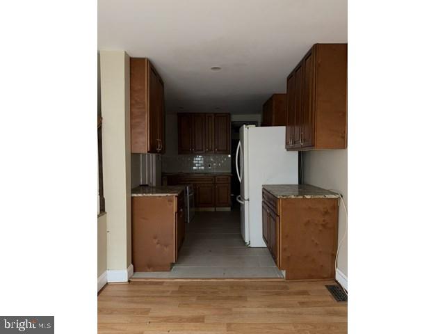 1611 Lemmon Street Baltimore, MD 21223 - Photo 5 of 20 a kitchen with sink and refrigerator
