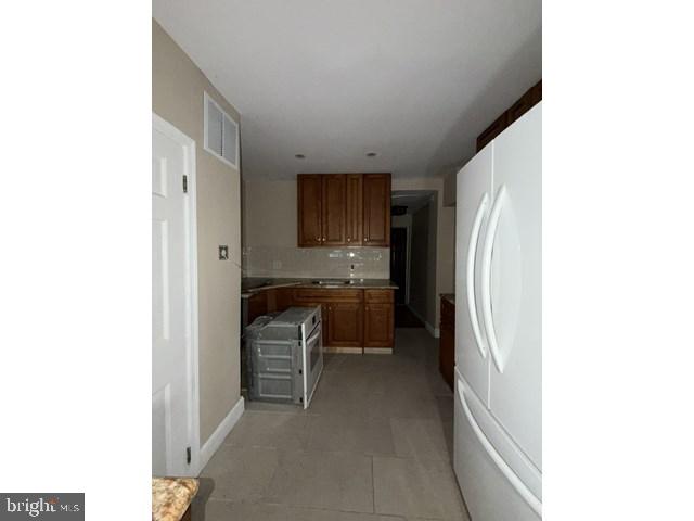 1611 Lemmon Street Baltimore, MD 21223 - Photo 6 of 20 a kitchen with a refrigerator and a sink