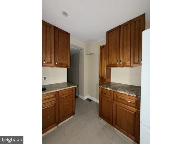 1611 Lemmon Street Baltimore, MD 21223 - Photo 7 of 20 a kitchen with stainless steel appliances granite countertop a stove and a refrigerator