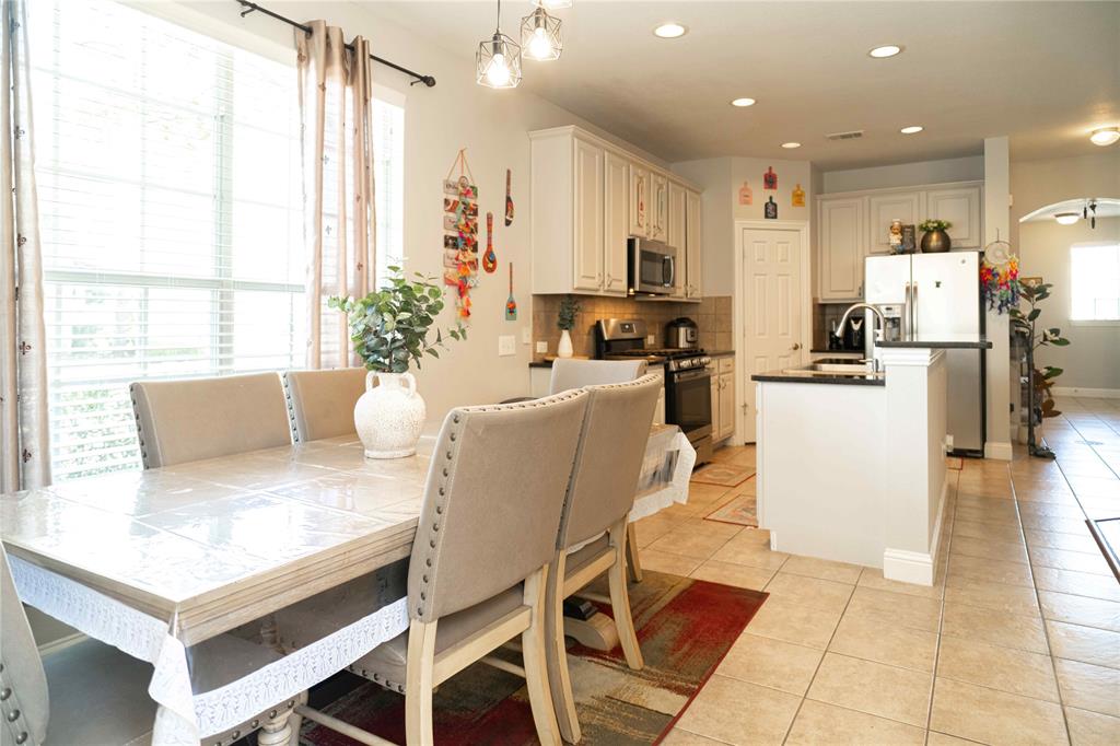 6851 Verde Irving, TX 75039 - Photo 18 of 40 a view of a dining room with furniture and a large window