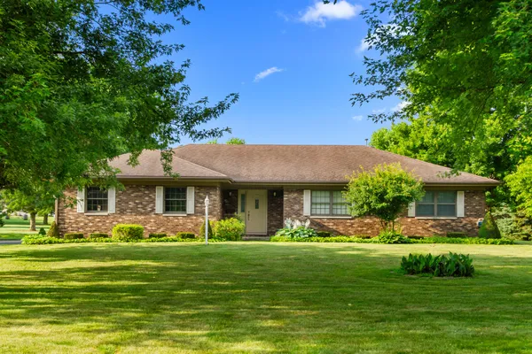 a front view of house with yard and green space
