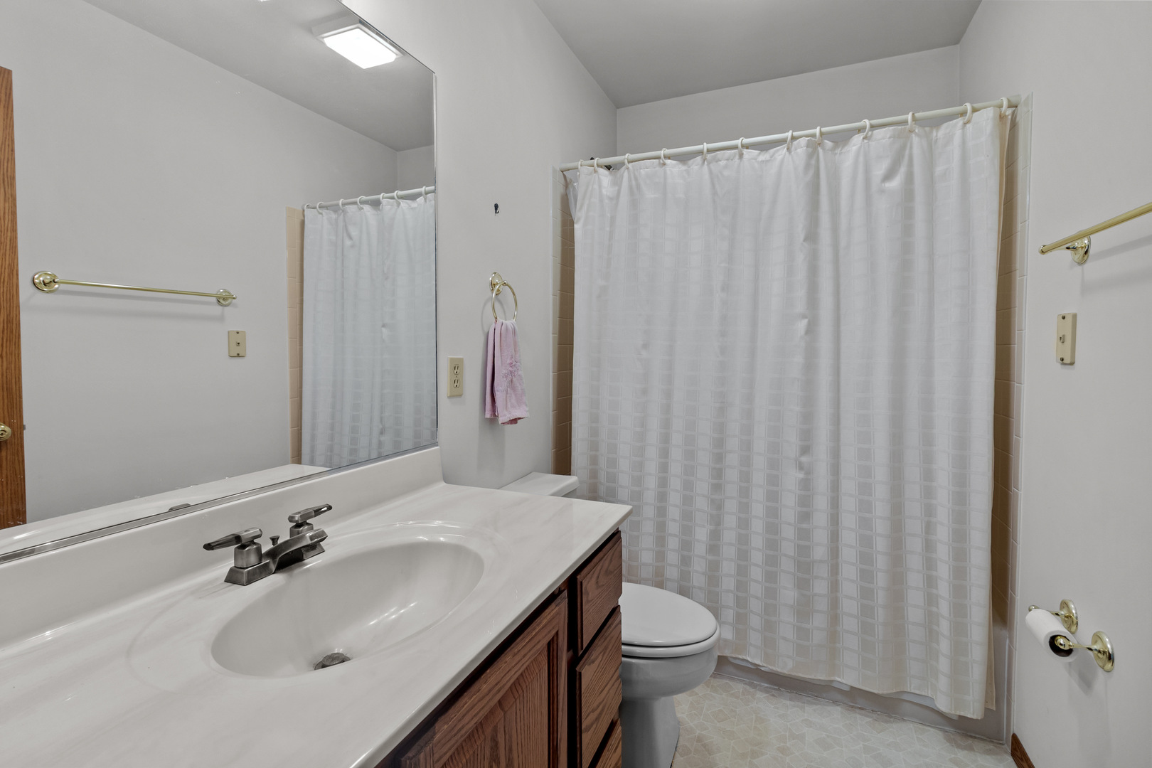 23201 Norma Lane Harvard, IL 60033 - Photo 15 of 24 a bathroom with a sink a toilet and shower curtain