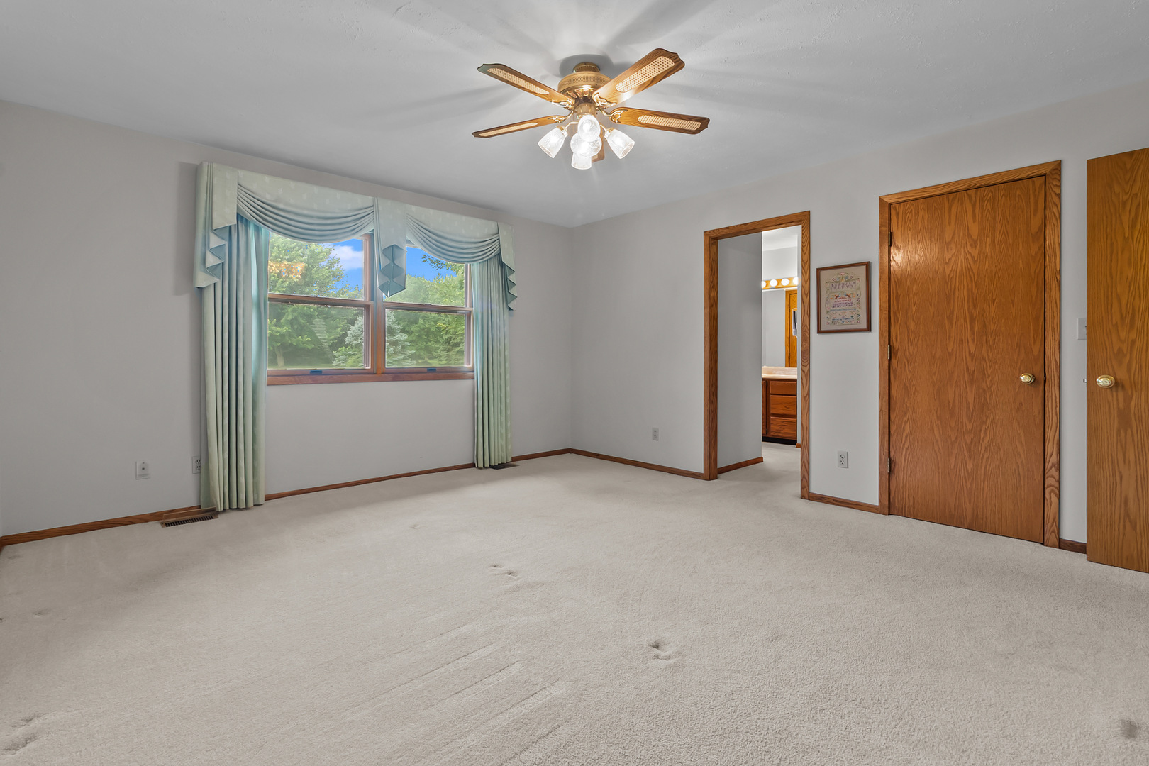 23201 Norma Lane Harvard, IL 60033 - Photo 9 of 24 an empty room with windows and a chandelier fan