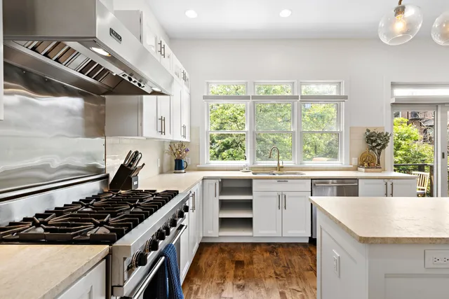 a kitchen with stove a sink and cabinets