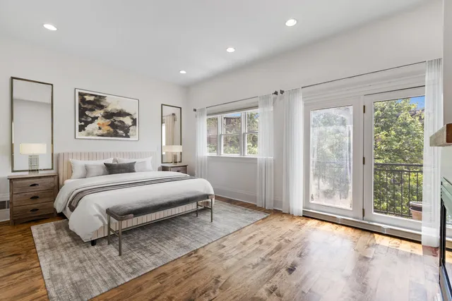 a spacious bedroom with a large bed and a window