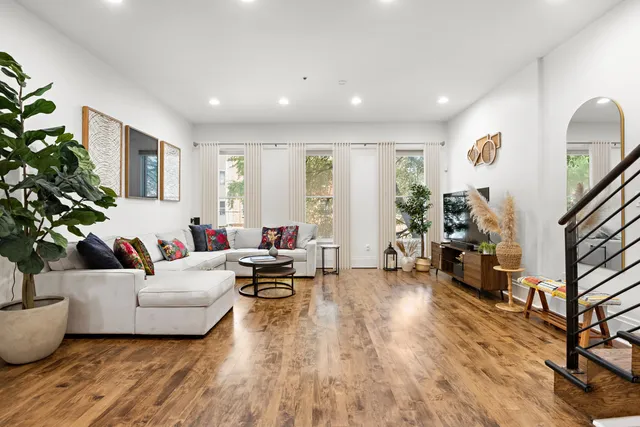 a living room with furniture and a potted plant