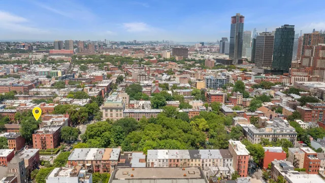 an aerial view of residential house with outdoor space and trees
