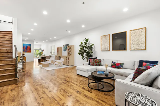 a living room with furniture kitchen view and a couch