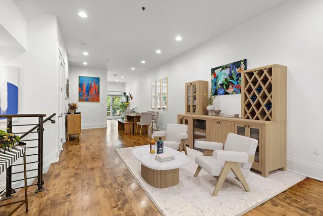 a living room with furniture and a wooden floor