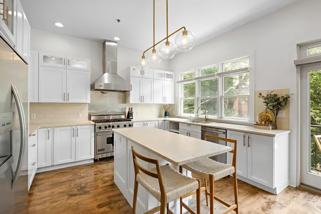 a kitchen with a stove a sink and a refrigerator