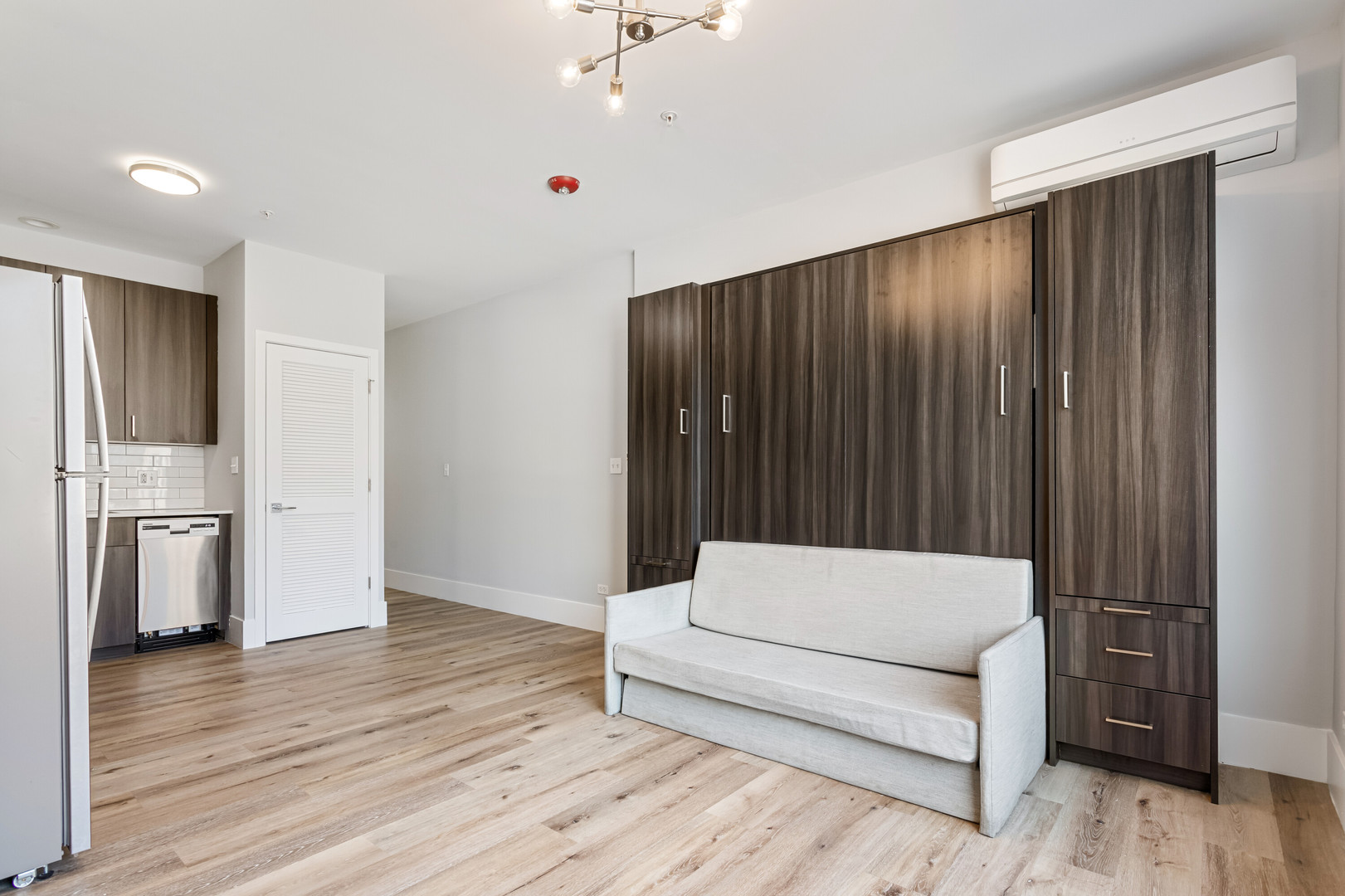 1531 West Howard Street, Unit 407 Chicago, IL 60626 - Photo 3 of 15 a living room with furniture and a refrigerator