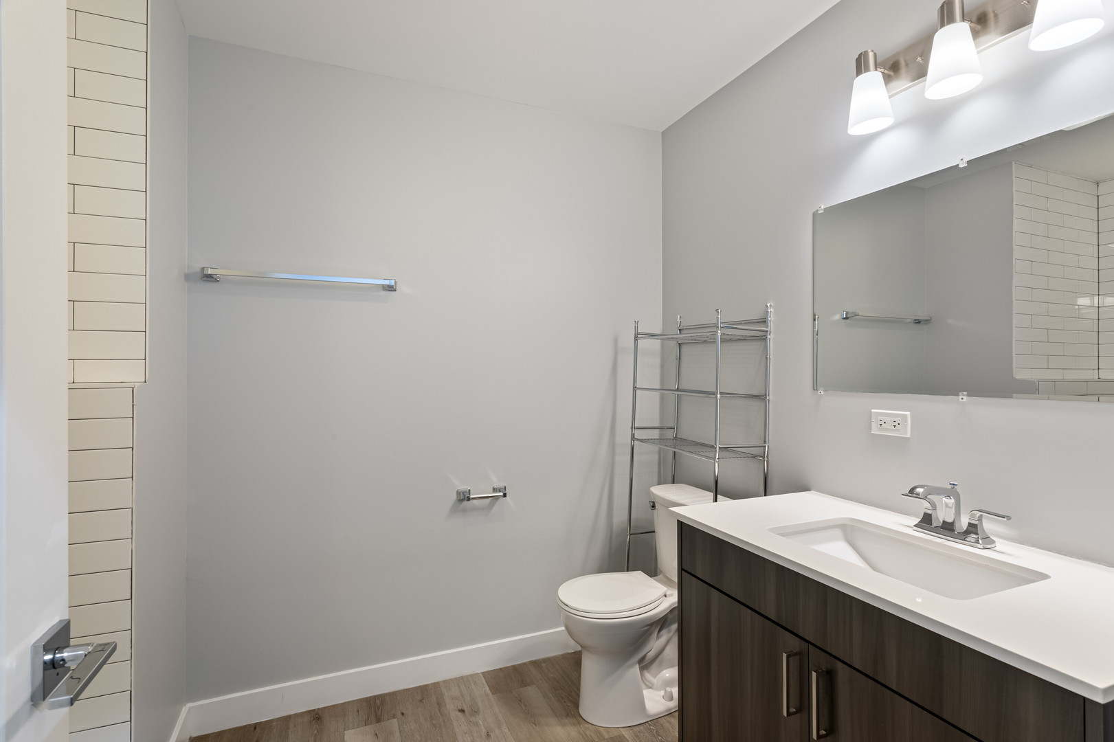 1531 West Howard Street, Unit 407 Chicago, IL 60626 - Photo 8 of 15 a bathroom with a toilet a sink a mirror and vanity
